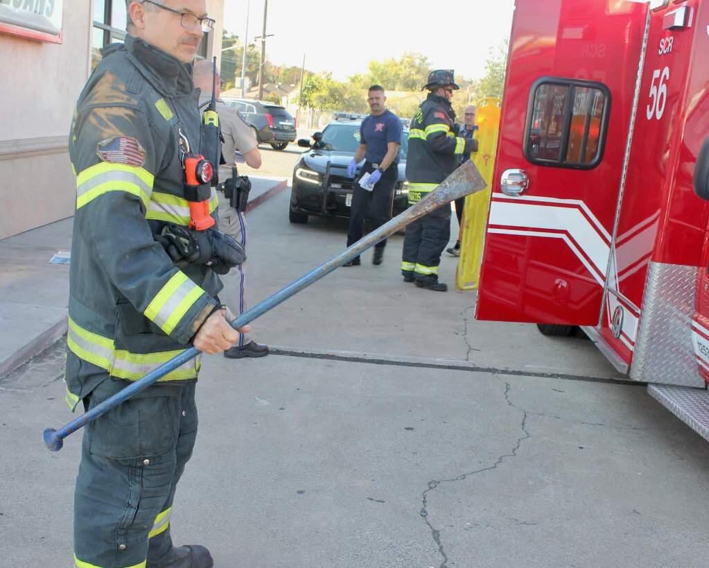 A firefighter holds the metal bar that fell off a moving big rig and impaled a person in the car behind the truck on Highway 99 near Sacramento, Saturday, Nov. 2, 2019. (CHP - SOUTH SACRAMENTO/ FACEBOOK)