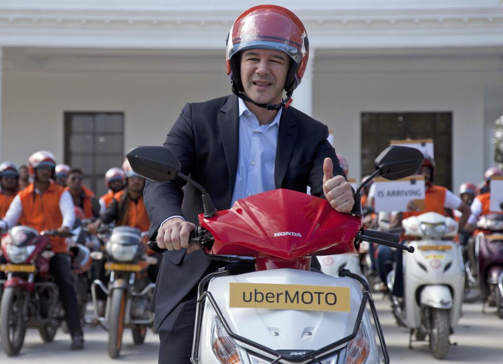 FILE - In this Dec. 13, 2016, file photo, Uber CEO Travis Kalanick, poses during the launch of its bike-sharing product, uberMOTO, in Hyderabad, India. Uber's CEO says he needs leadership help after a video has emerged of him arguing heatedly with a driver about fares. (AP Photo/Mahesh Kumar A., File)