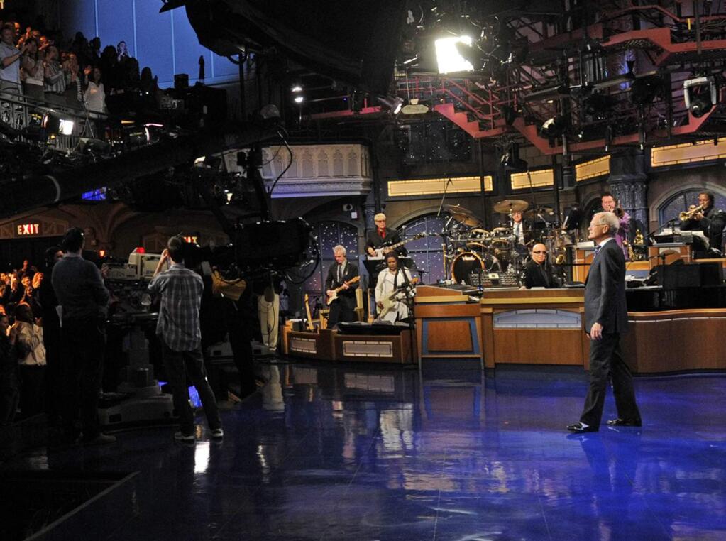 In this image released by CBS, David Letterman receives a standing ovation during the taping of his final 'Late Show with David Letterman,' Wednesday, May 20, 2015 at the Ed Sullivan Theater in New York. After 33 years in late night television, 6,028 broadcasts, nearly 20,000 total guest appearances, 16 Emmy Awards and more than 4,600 career Top Ten Lists, David Letterman is retiring. (Jeffrey R. Staab/CBS via AP)