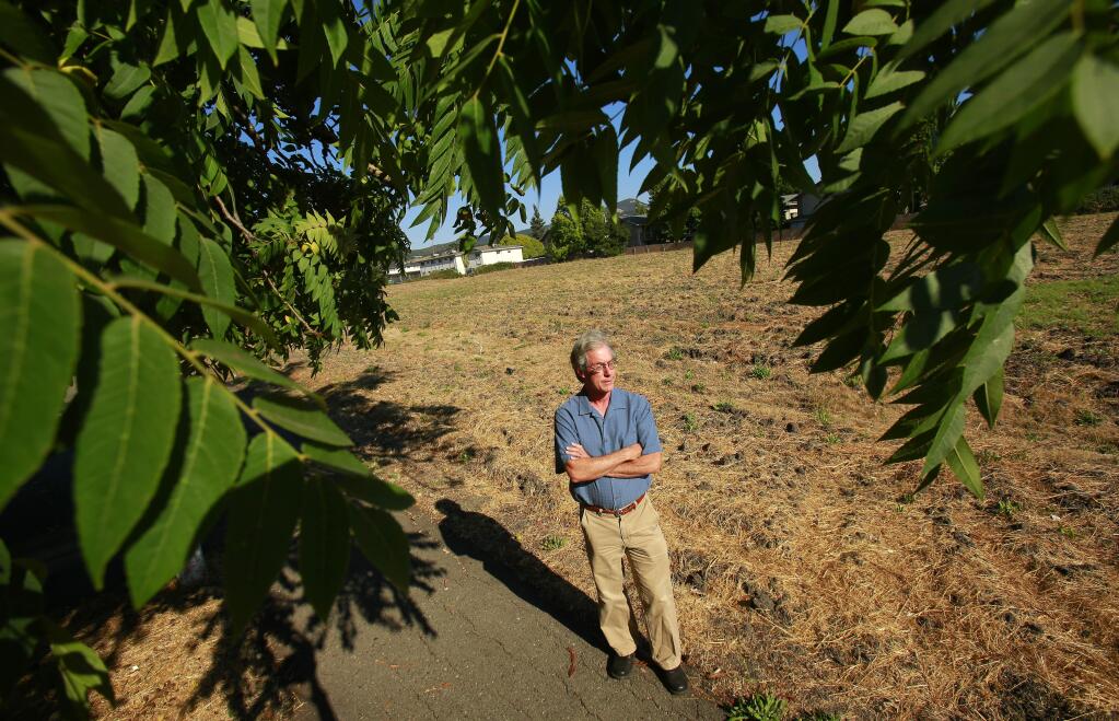 Steve Rabinowitsh stands by the strip of land once envisioned to be used for a freeway overpass that he hopes to now turn into a bike path and park system near Franquette Avenue in Santa Rosa on Thursday, August 21, 2014. (Conner Jay/The Press Democrat)