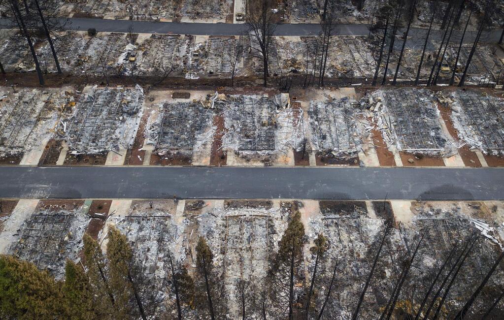FILE- This Dec. 3, 2018, file photo shows homes leveled by the Camp Fire line the Ridgewood Mobile Home Park retirement community in Paradise, Calif. Insurance claims for California's deadly November 2018 wildfires have topped $12 billion. That makes them the most expensive series of fires in state history. The number released Wednesday May 8, 2019 by Insurance Commissioner Ricardo Lara covers the fire that destroyed the Northern California town of Paradise and two Southern California fires. Most of the damages relate to the Paradise fire, which killed 85 people and destroyed nearly 19,000 buildings. (AP Photo/Noah Berger, File)
