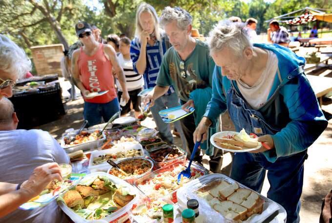 In Doyle Park, Friday Aug. 15, low-income and homeless people gather for a barbecue and discussion about homelessness in Sonoma County. (Kent Porter/Press Democrat)