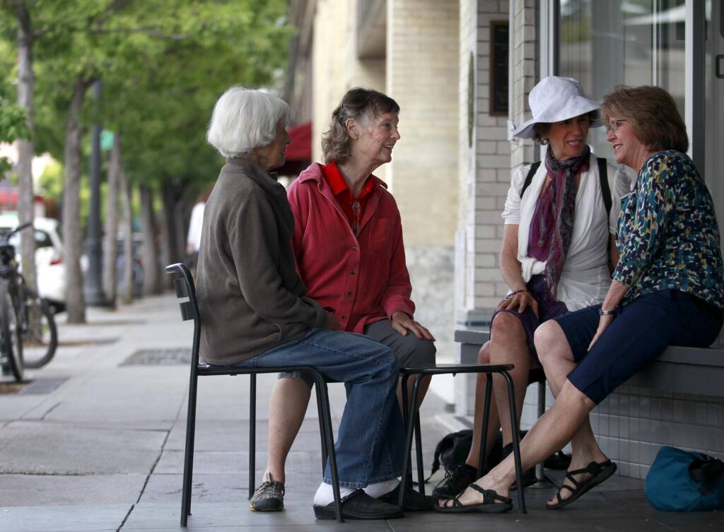 Anne Greenblatt, second from left, of the Village Network, talks with members Nora Pearl, center right, Doris Nelson, right, and prospective member Carolyn Wagenvoord, left, as they meet up in Petaluma on Tuesday, July 15, 2014. (BETH SCHLANKER / The Press Democrat)