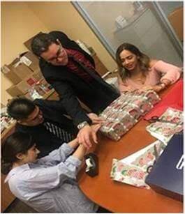 Wells Fargo team members at Micron Branch wrap gifts for employees affected by the fires include (from left) Marta Ayvazyan, Albert Huynh, Garrett Avila, and Claudia Fernandez.