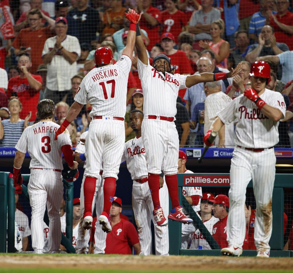 Philadelphia Phillies' Rhys Hoskins, left, celebrates his two-run home run with Maikel Franco, right, during the fifth inning of a baseball game against the San Francisco Giants, Tuesday, July 30, 2019, in Philadelphia. (AP Photo/Chris Szagola)