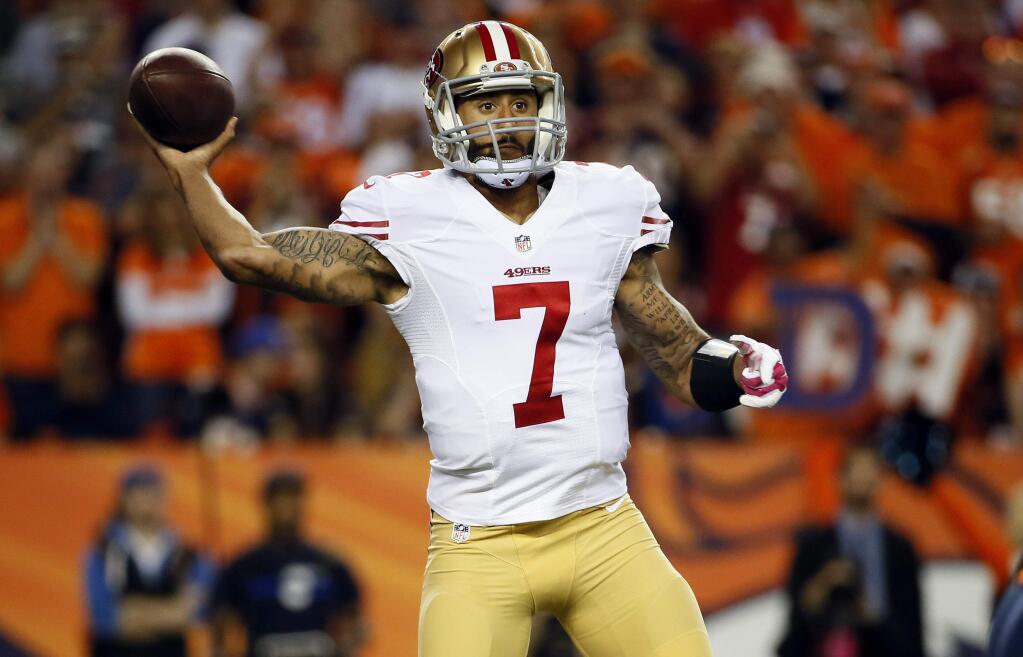 San Francisco 49ers quarterback Colin Kaepernick (7) looks to pass again the Denver Broncos during the first half of an NFL football game, Sunday, Oct. 19, 2014, in Denver. (AP Photo/Jack Dempsey)