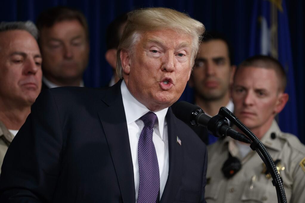 President Donald Trump speaks at the Las Vegas Metropolitan Police Department Wednesday, Oct. 4, 2017, in Las Vegas, after meeting with victims of the Las Vegas shooting at a hospital and then with first responders who were on duty Sunday night. (AP Photo/Evan Vucci)