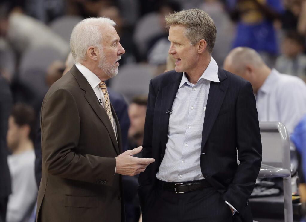 San Antonio Spurs head coach Gregg Popovich, left, and Golden State Warriors head coach Steve Kerr, right, visit before a game, Thursday, Nov. 2, 2017, in San Antonio. (AP Photo/Eric Gay)