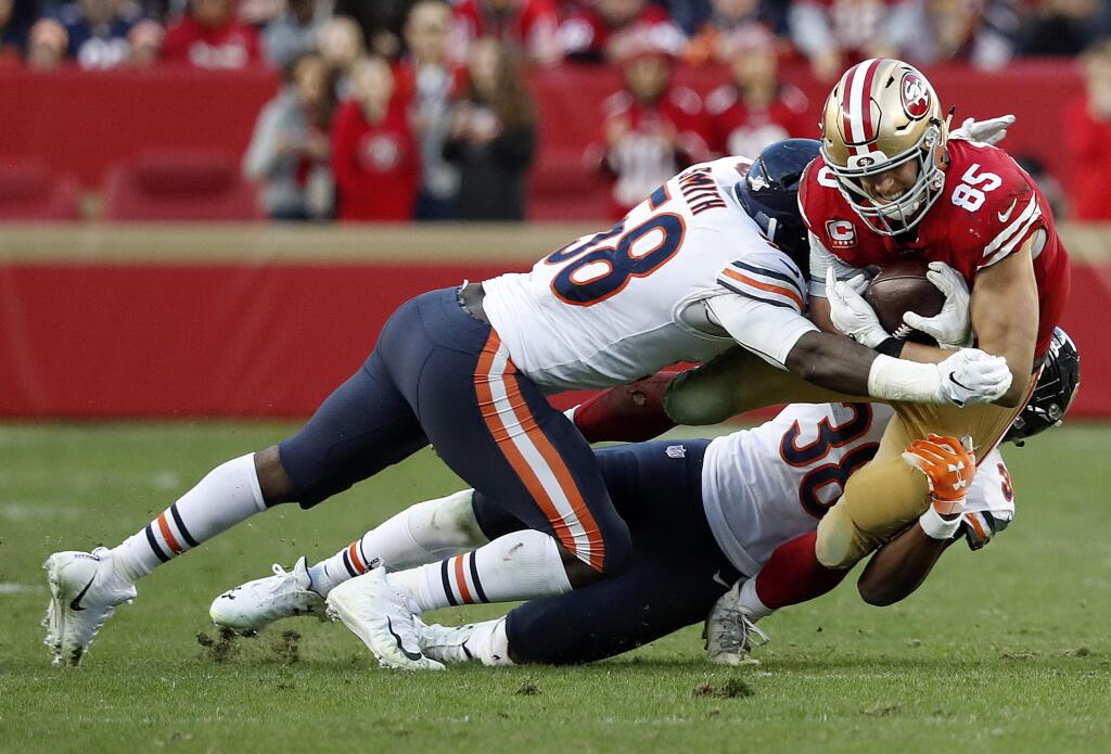 San Francisco 49ers tight end George Kittle (85) is tackled by Chicago Bears inside linebacker Roquan Smith (58) and strong safety Adrian Amos Jr. (38) during the second half of an NFL football game in Santa Clara, Calif., Sunday, Dec. 23, 2018. (AP Photo/Tony Avelar)