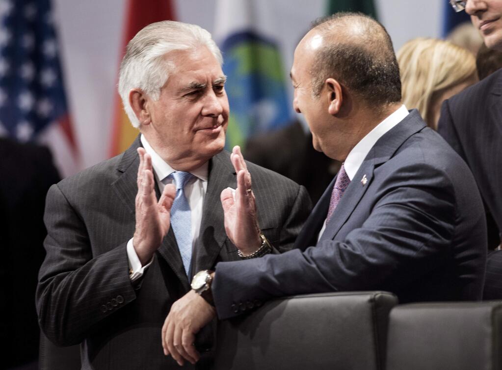 US Secretary of State Rex Tillerson, left, and Turkey's Foreign Minister Mevlut Cavusoglu talk ahead of the opening session meeting of the G20 foreign ministers at the World Conference Center in Bonn, Germany, Thursday, Feb. 16, 2017. Foreign ministers from 20 of the world's leading nations met Thursday in the former German capital to discuss current conflicts and ways to prevent future crises against a backdrop of uncertainty among allies and adversaries about the direction of U.S. foreign policy. (AP Photo/ Brendan Smialowski, Pool)