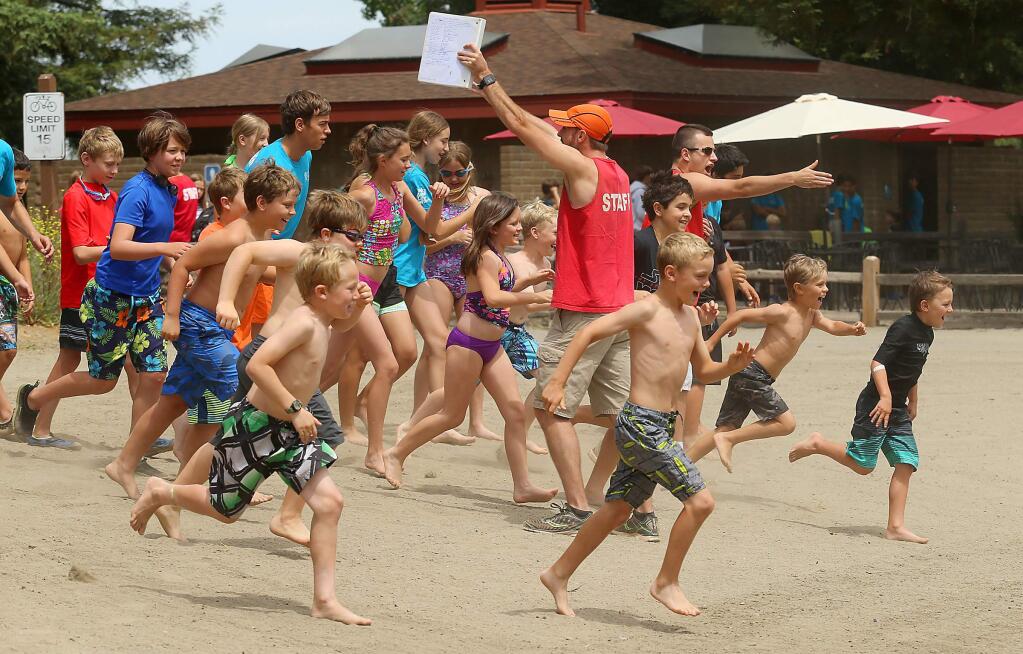 Camp Wa-Tam participants sprint down the beach into the lagoon at Spring Lake in 2017. Santa Rosa Recreation & Parks announced May 4 that summer camps are canceled because of the coronavirus pandemic. JOHN BURGESS/The Press Democrat