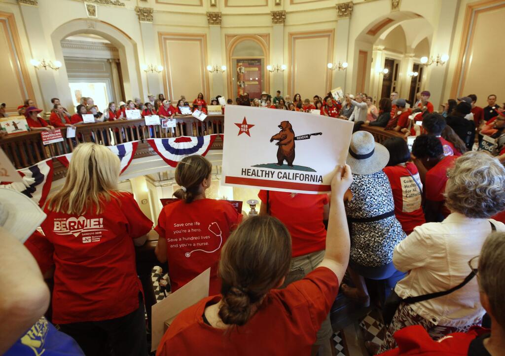 Members of the California Nurses Association and supporters rally on the second floor rotunda at the Capitol calling for a single-payer health plan, Wednesday, June 28, 2017, in Sacramento, Calif. The demonstrators were demanding that Assembly Speaker Anthony Rendon, D-Paramount, bring a health care bill, SB562, by state Senators Ricardo Lara, D-Bell Garden, and Toni Atkins, D-San Diego, to a vote in the Assembly. (AP Photo/Rich Pedroncelli)