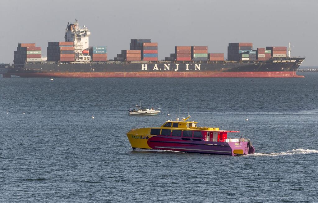FILE - In this Sept. 1, 2016, file photo, South Korea's Hanjin Shipping Co. container ship Hanjin Montevideo, top, is anchored outside the Port of Long Beach in Long Beach, Calif. South Korea's financial regulator said Monday, Sept. 5, 2016, that financially troubled Hanjin Shipping Co. will seek stay orders in dozens of countries this week to help minimize disruptions caused by its slide into bankruptcy proceedings. The Financial Services Commission said Hanjin, the country's largest ocean container shipper, will seek bankruptcy protection in 43 countries, including Canada, Germany and Britain. (AP Photo/Damian Dovarganes, File)