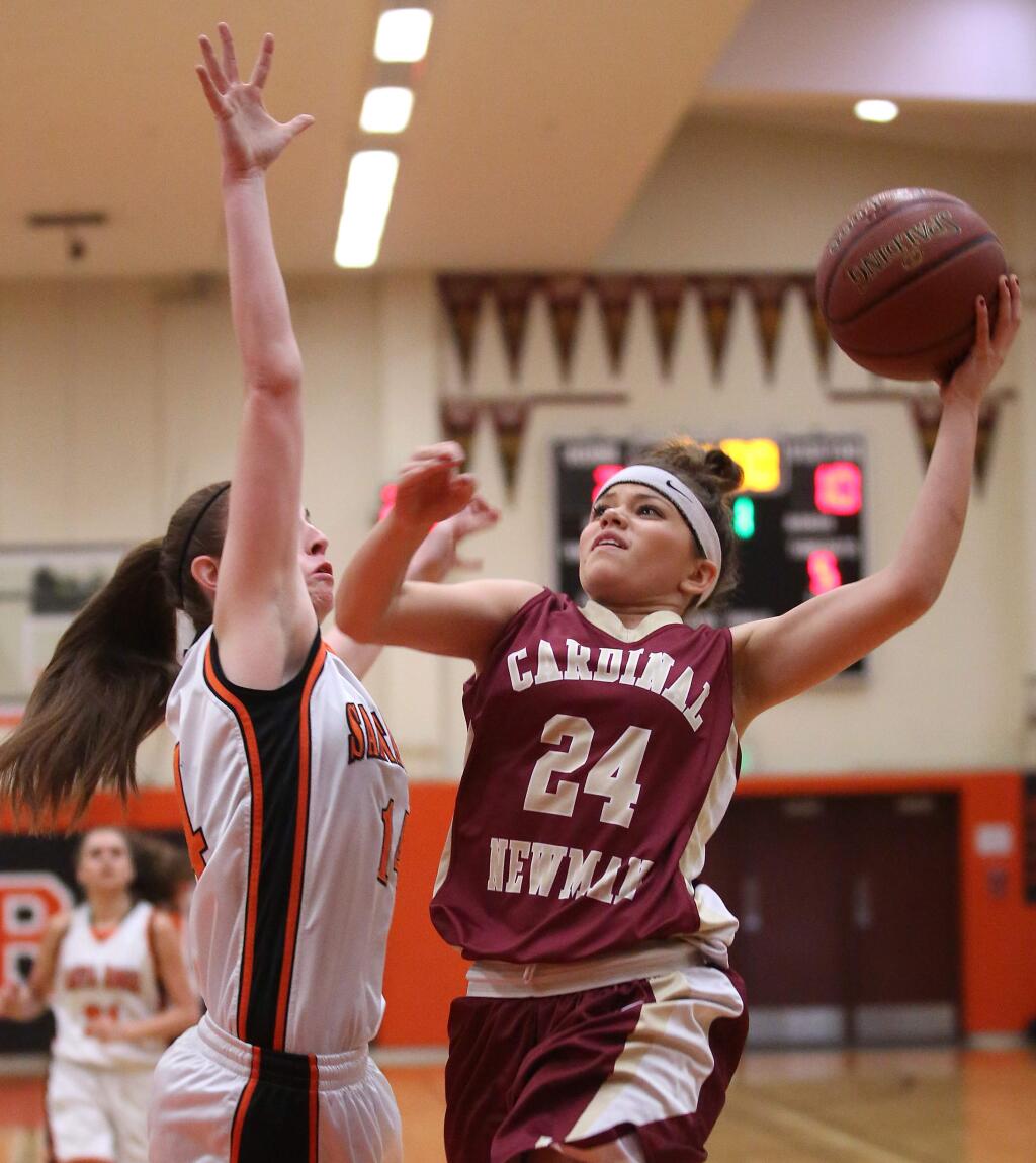 Cardinal Newman's Jasmine Henderson goes to the basket as Santa Rosa's Kylie Oden defends during the game held at Santa Rosa High School, Wednesday, January 21, 2015. (Crista Jeremiason / The Press Democrat)