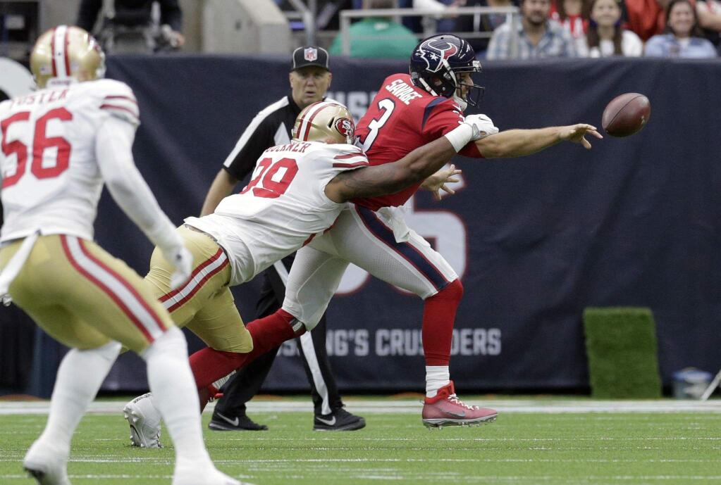 Houston Texans quarterback Tom Savage gets rid of the ball as he is hit by San Francisco 49ers defensive tackle DeForest Buckner during the first half Sunday, Dec. 10, 2017, in Houston. (AP Photo/Michael Wyke)