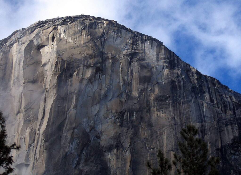 File - This Oct. 20, 2004 file photo shows the climbing face of El Capitan in Yosemite National Park. Two men, Kevin Jorgeson and Tommy Caldwell, are roughly halfway through climbing El Capitan: a free climb of a half-mile section of exposed granite in California's Yosemite National Park. El Capitan, the largest monolith of granite in the world, rises more than 3,000 feet above the Yosemite Valley floor. (AP Photo/Ben Margot, File)