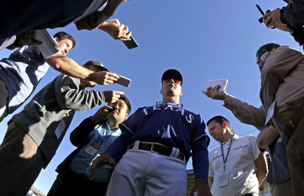 Texas Rangers manager Jeff Banister talks to reporters after the Rangers' spring training baseball game against the Kansas City Royals on Wednesday, March 4, 2015, in Surprise, Ariz. The Royals won 13-2. (AP Photo/Charlie Riedel)