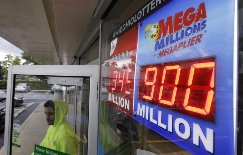 The Mega Millions jackpot is displayed as a customer leaves the Corner Market, Wednesday, Oct. 17, 2018, in Lyndhurst, Ohio. The next drawing will be Friday. (AP Photo/Tony Dejak)