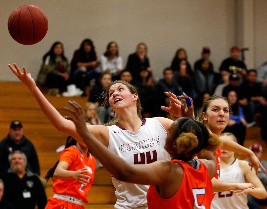 Cardinal Newman's Lauren Walker reaches for an offensive rebound during the first half of the NCS Division 4 championship game between Cardinal Newman and St. Joseph Notre Dame high schools in Santa Rosa on Saturday, March 4, 2017. (Alvin Jornada / The Press Democrat)