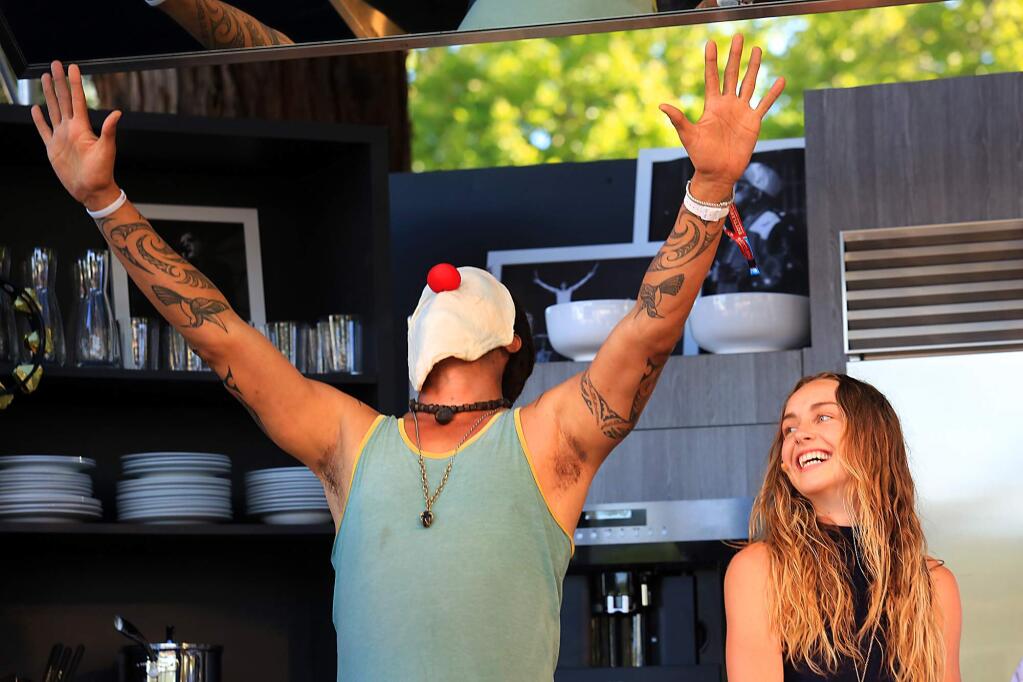 Musician Michael Franti makes a pizza dough face with Zella Day during a cooking demonstration on the Culinary Stage at the BottleRock Napa Valley music festival, Saturday, May 30, 2015. (John Burgess / The Press Democrat)