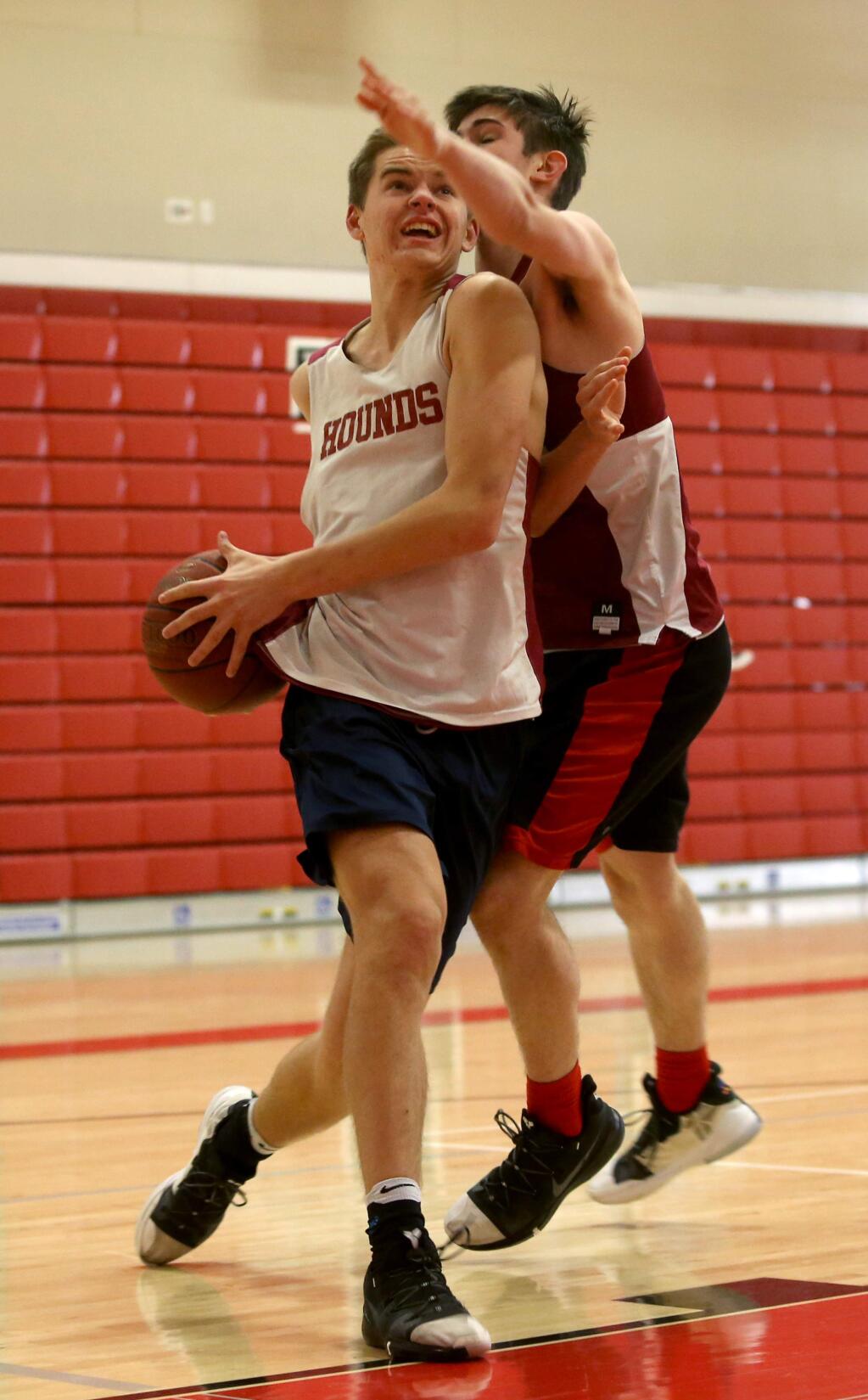 Sophomore Dylan Hayman is guarded by junior Avery Billman as he tries to drive toward the basket during practice at Healdsburg High School on Wednesday, January 2, 2019 in Healdsburg, California. (BETH SCHLANKER/The Press Democrat)