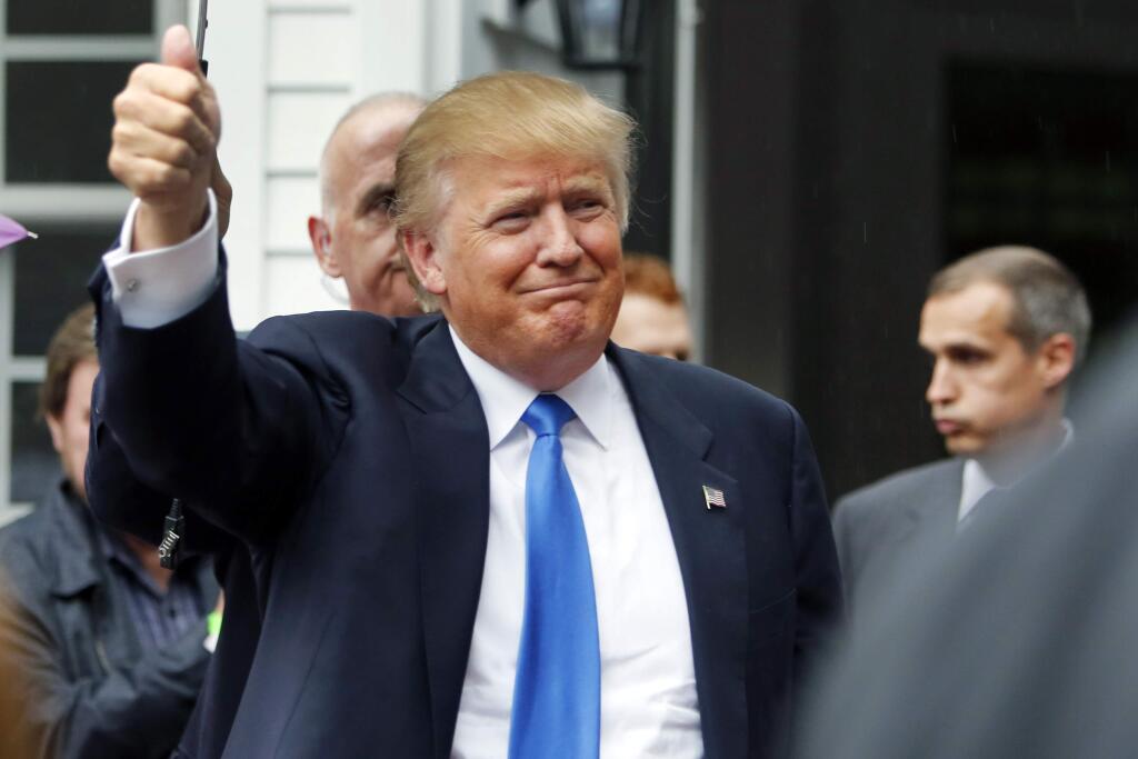 Republican presidential candidate Donald Trump waves as he arrives at a house party Tuesday, June 30, 2015, in Bedford, N.H. (AP Photo/Jim Cole)