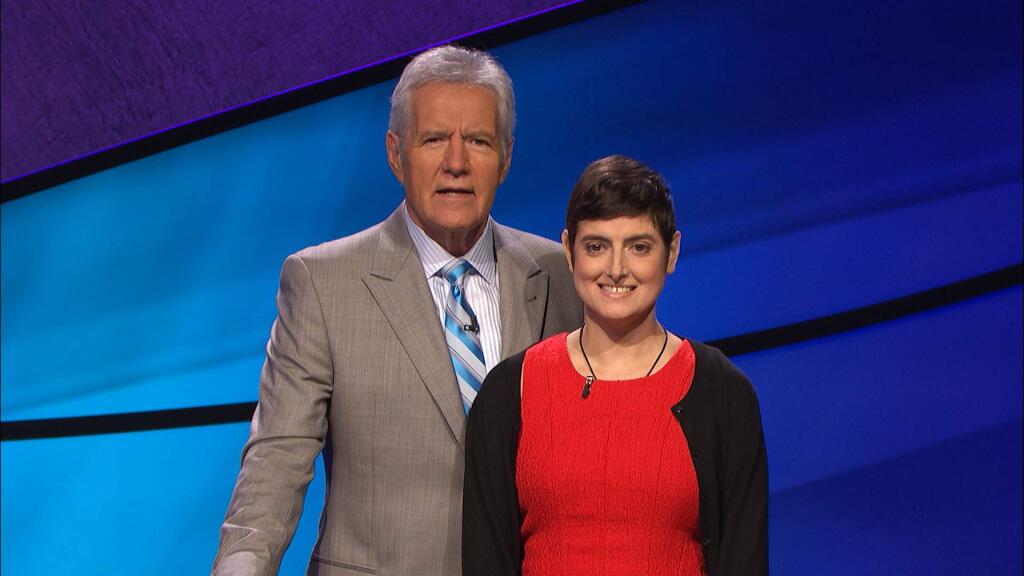 In this Aug. 31, 2016 photo provided by Jeopardy Productions, Inc., Cindy Stowell, right, appears on the 'Jeopardy!' set with Alex Trebek in Culver City, Calif. Stowell, who competed on 'Jeopardy!' while battling terminal colon cancer has died the week before her episode was set to air on Tuesday, Dec. 13, but prize money has gone to cancer research as she wished. (Courtesy of Jeopardy Productions, Inc. via AP)
