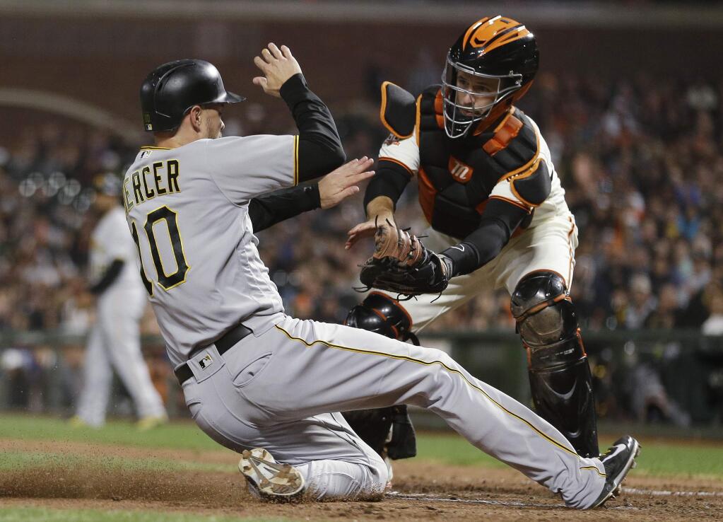 The Pittsburgh Pirates' Jordy Mercer slides, but is tagged out by San Francisco Giants catcher Buster Posey during the seventh inning Thursday, Aug. 9, 2018, in San Francisco. (AP Photo/Eric Risberg)