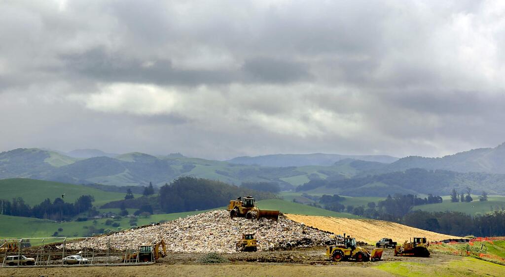 Heavy equipment spreads and compresses garbage at the Sonoma County Landfill in 2013. (KENT PORTER/ PD FILE)