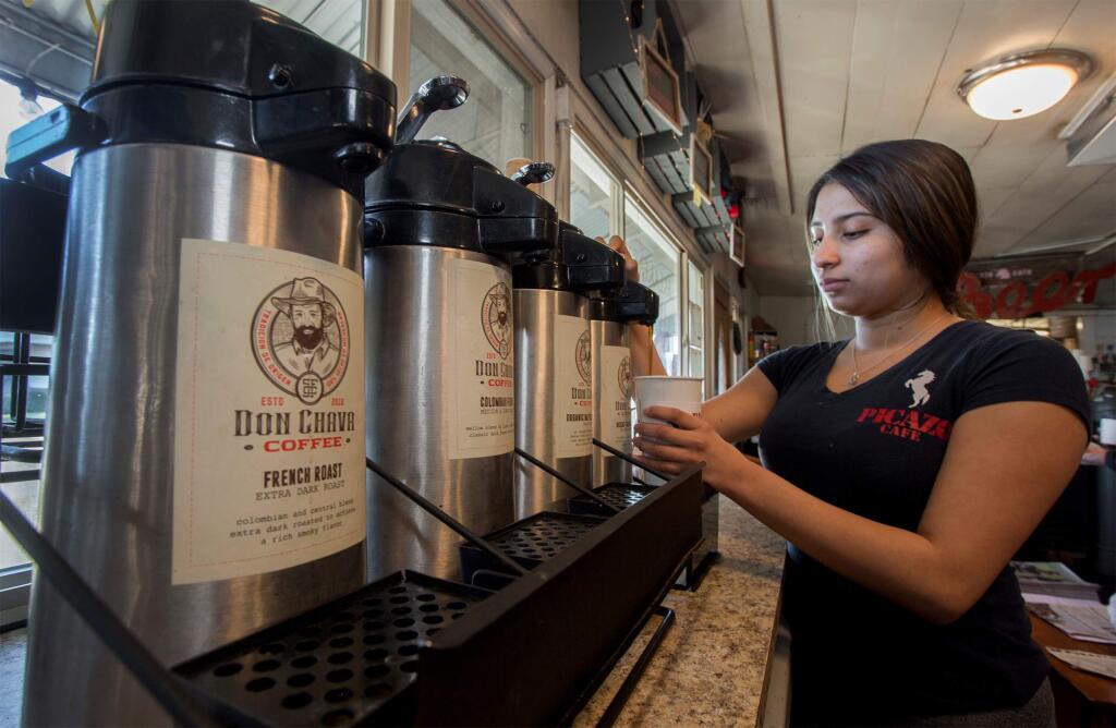 Server Brianda Prudente pours a cup of Don Chava coffee, now available at the Picazo Cafe. (Photo by Robbi Pengelly/Index-Tribune)