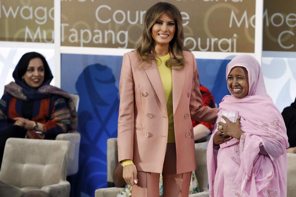 First lady Melania Trump, center, presents an International Women of Courage award to L'Malouma Said of Mauritania, Friday March 23, 2018, at the State Department in Washington. (AP Photo/Jacquelyn Martin)