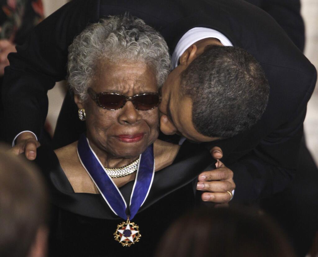 In a Feb. 15, 2011 file photo, President Barack Obama kisses author and poet Maya Angelou after awarding her the 2010 Medal of Freedom during a ceremony in the East Room of the White House in Washington. Maya Angelou's iconic words and lyrics will be blended with hip-hop beats for a new album called 'Caged Bird Songs.' (AP Photo/Charles Dharapak, File)