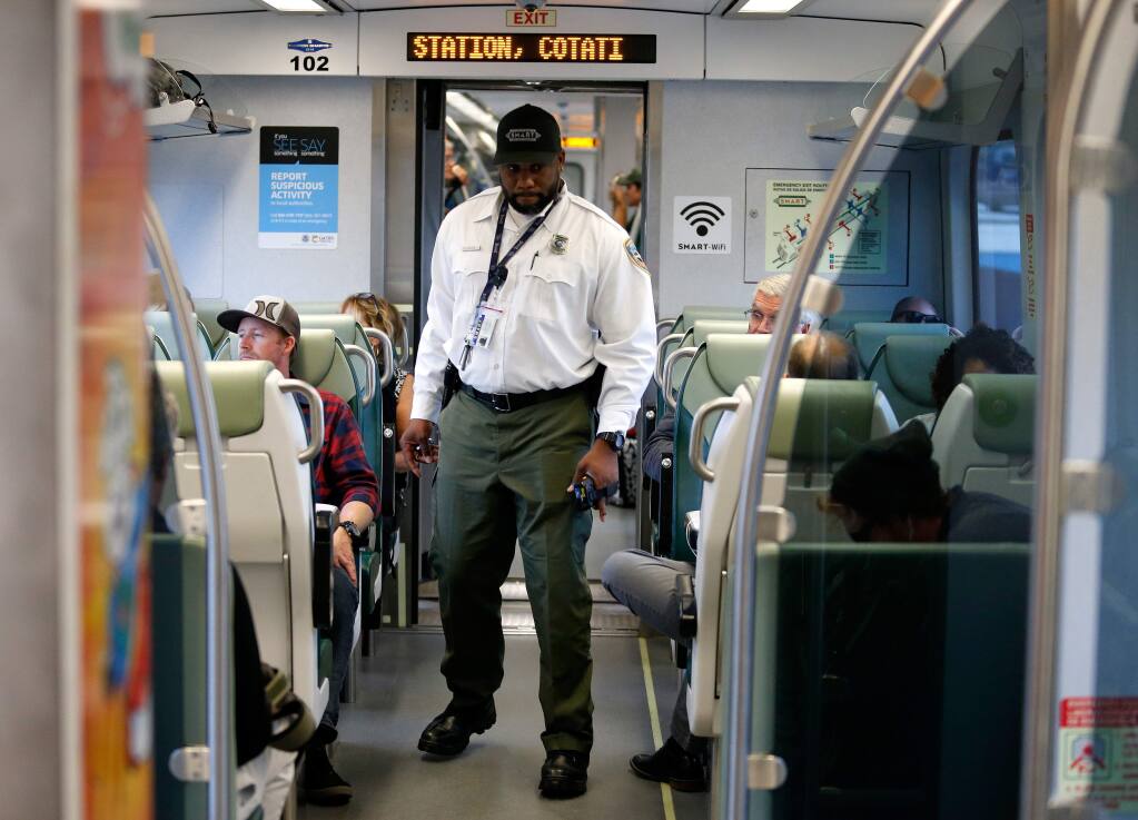 SMART train conductor James Taylor walks through the cars as the train heads towards the station in Cotati, California, on Wednesday, September 20, 2017. (Alvin Jornada / The Press Democrat)
