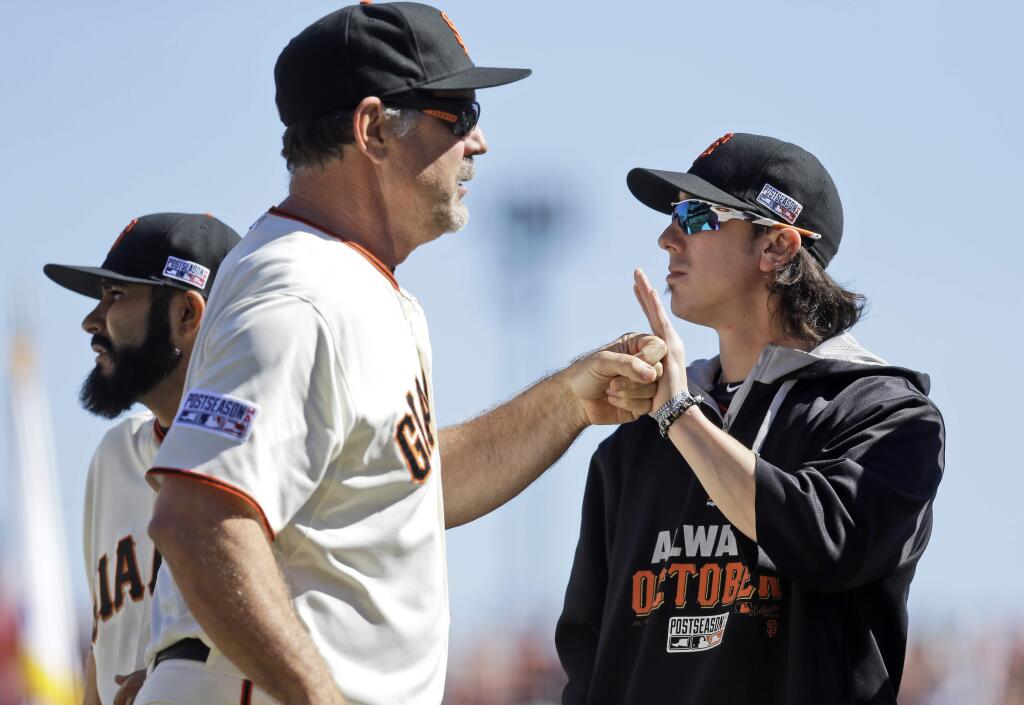 San Francisco Giants manager Bruce Bochy punches fists with pitcher Tim Lincecum before Game 3 of baseball's NL Division Series against the Washington Nationals in San Francisco, Monday, Oct. 6, 2014. (AP Photo/Ben Margot)
