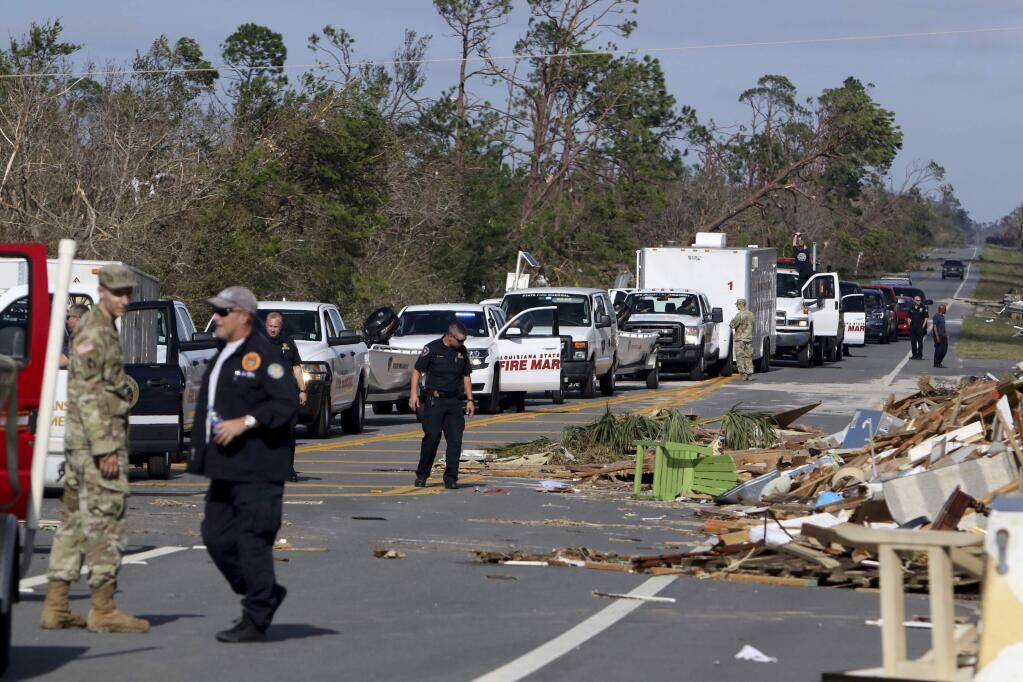 Tampa Bay Times Emergency workers form a caravan at the western edge of town at Mexico Beach, population 1200, where they planned to join the South Florida Search and Rescue Task Force to clear home and to make contact with survivors in the township which lay devastated on Thursday, Oct 11, 2018, after Hurricane Michael made landfall on Wednesday in the Florida Panhandle. Brock said he stayed in the city to ride out the storm. (Douglas R. Clifford/Tampa Bay Times via AP)