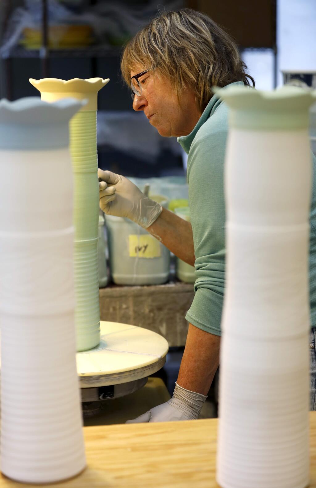 Potter Marge Margulies glazes a pot at her studio in Guerneville on Monday, May 6, 2019. (BETH SCHLANKER/PD)