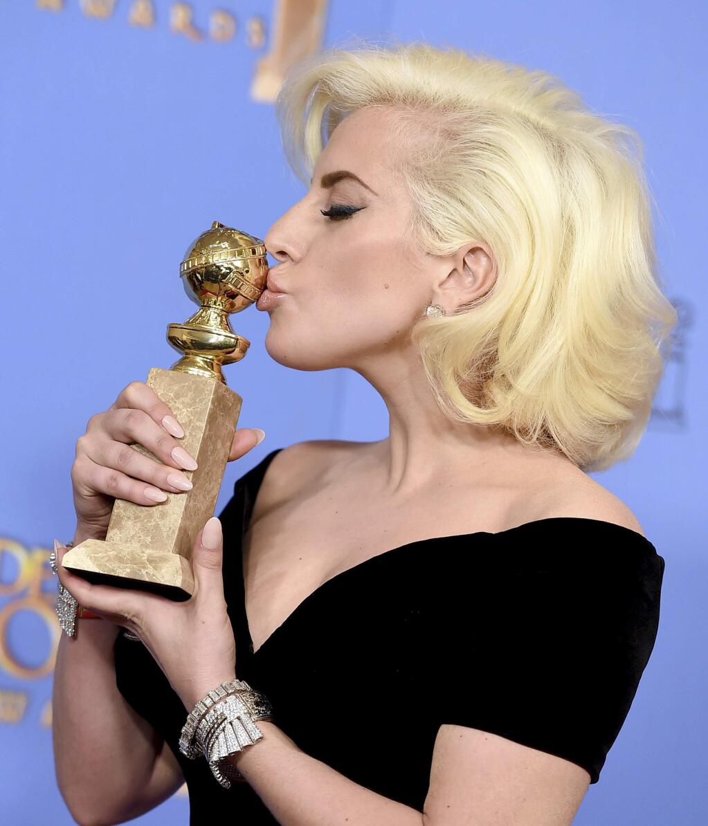 FILE - In this Jan. 10, 2016 file photo, Lady Gaga poses in the press room with the award for best performance by an actress in a limited series or a motion picture made for TV for 'American Horror Story: Hotel' at the 73rd annual Golden Globe Awards in Beverly Hills, Calif. Lady Gaga released her latest album, 'Joanne,' on Friday, Oct. 21, 2016. (Photo by Jordan Strauss/Invision/AP, File)
