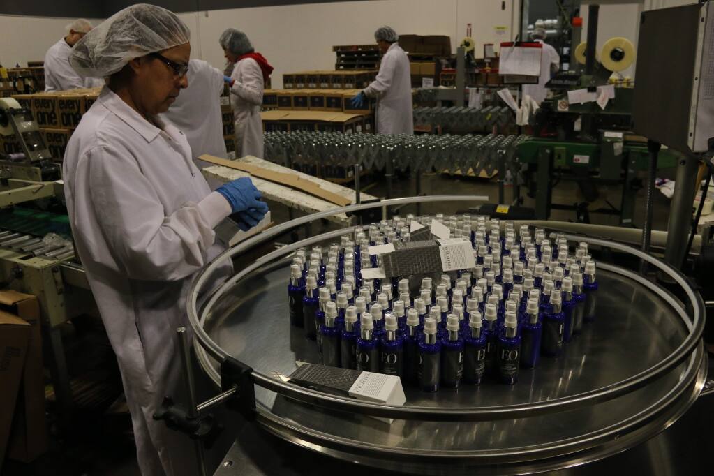 Ana Millan, who has worked for the company for 11 years, packs bottles of the new EO Ageless Skincare product in the San Rafael plant on Jan. 9, 2015. (Jeff Quackenbush/The Business Journal)
