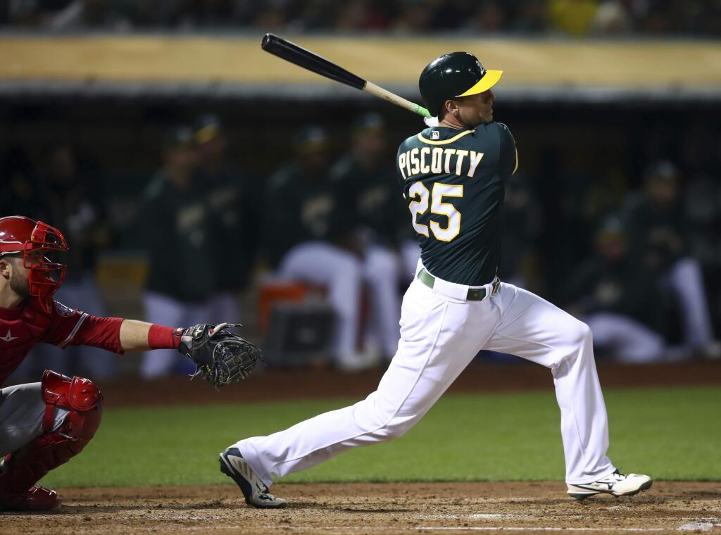 The Oakland Athletics' Stephen Piscotty follows through on a two-run double off the Los Angeles Angels' Felix Pena during the fourth inning Wednesday, Sept. 19, 2018, in Oakland, Calif. (AP Photo/Ben Margot)