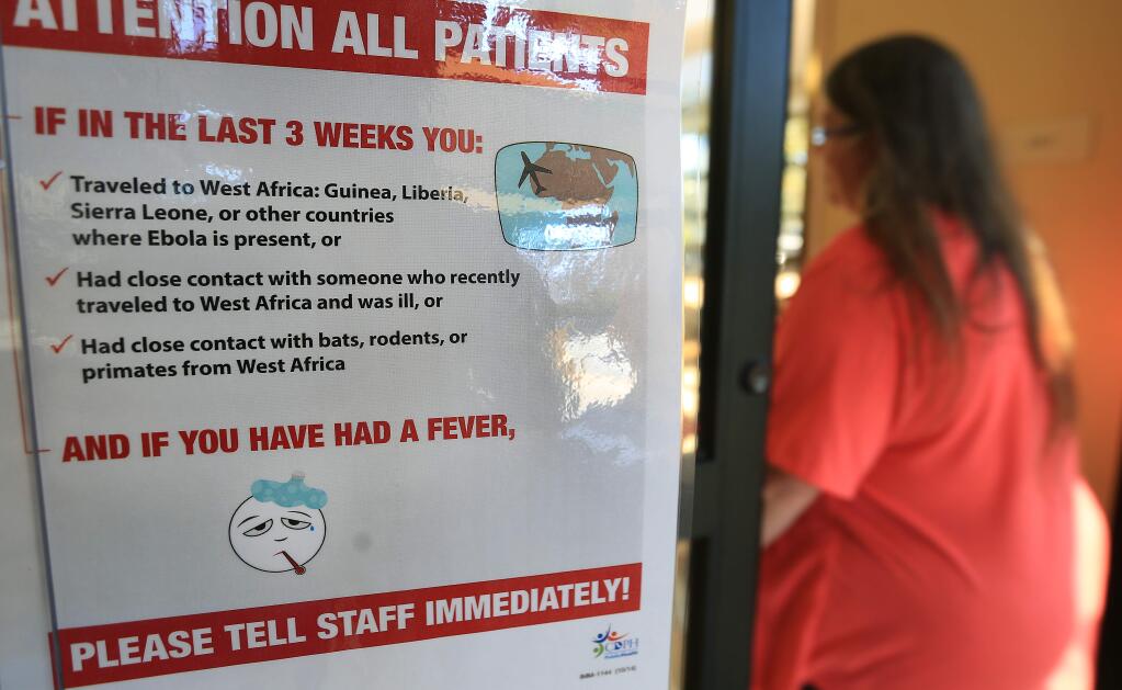 A warning sign at the entrance to the ER at Memorial Hospital in Santa Rosa alert those who have traveled abroad to countries affected by the Ebola crisis, to be checked if they experience any of Ebola's symptoms. (KENT PORTER/ PD)