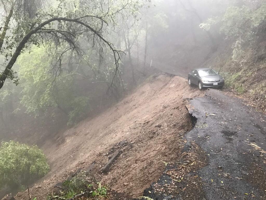 A car was still stuck on Old Cazadero Road on Wednesday, Feb. 8, 2017, a day after pounding rain caused a mudslide. (BETH SCHLANKER/ PD)