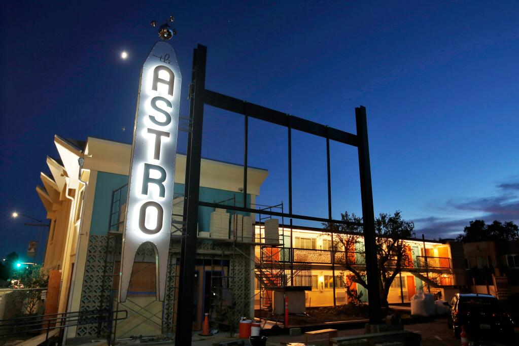 The new Astro Hotel sign lights up the evening while ongoing renovations transform the former infamous motel into a boutique hotel, in Santa Rosa on Sept. 28, 2017. Efforts to revive The Astro proved unsuccessful until 2016, when Santa Rosa-based Spinster Hospitality bought the property with the intention of preserving its history, but with a fresh spin. (Alvin Jornada / The Press Democrat)
