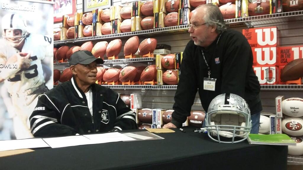 LUKE STRAUB FOR THE ARGUS-COURIERWillie Brown talks with RobHemphill from National Sports Memorabilia about the good times with the Oakland Raiders.