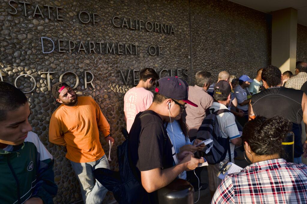 People line up at the California Department of Motor Vehicles prior to opening in the Van Nuys section of Los Angeles on Tuesday, Aug. 7, 2018. California lawmakers are seeking answers from the DMV about long wait times, prompted by their own experiences at agency offices in their districts and complaints from their constituents. (AP Photo/Richard Vogel)