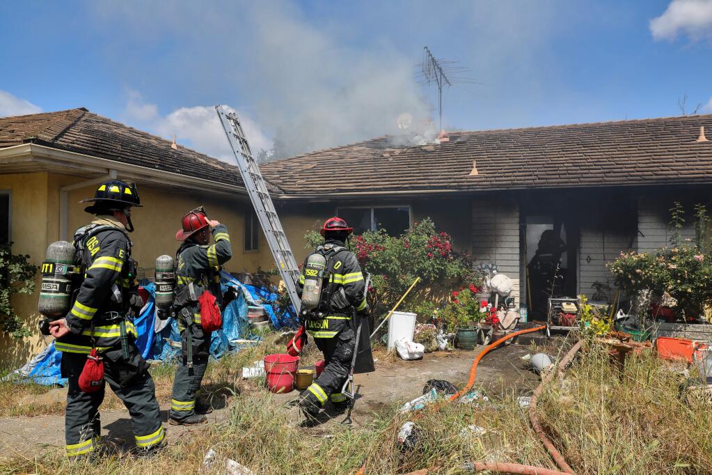Firefighters from multiple agencies respond to a structure fire on the 11000 block of Old Redwood Highway, near Windsor on Tuesday, May 19, 2020. (Christopher Chung/ The Press Democrat)