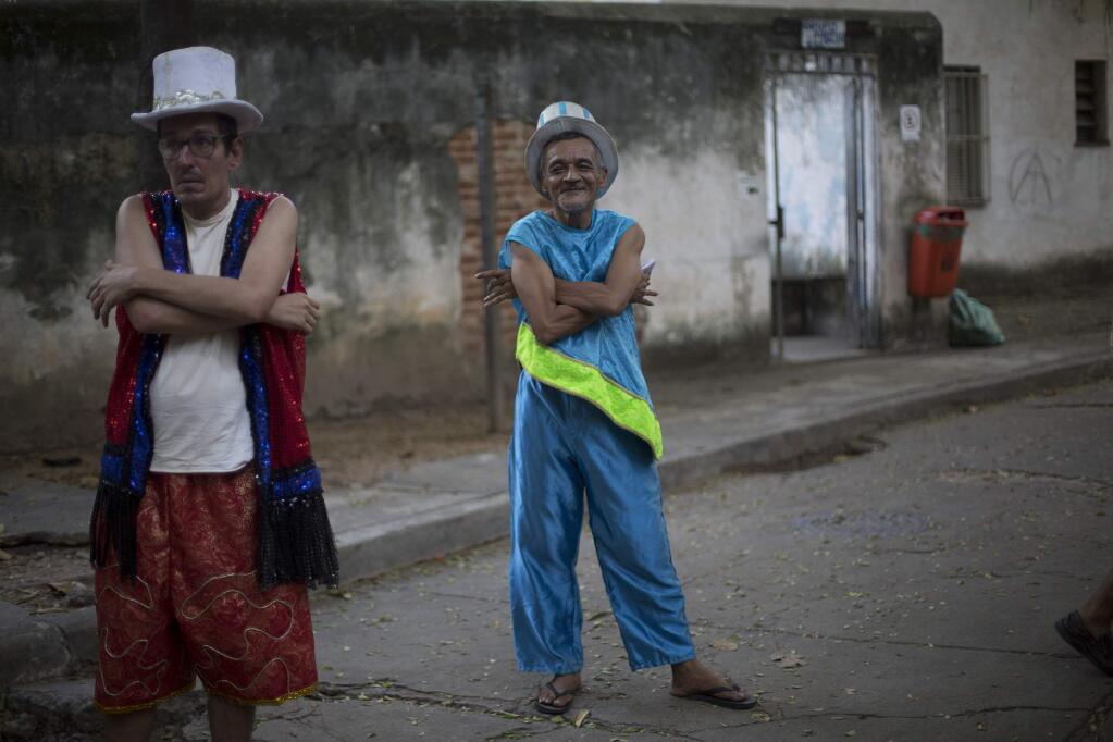 Patients from the Nise da Silveira mental health institute wait for the beginning of a carnival parade coined, in Portuguese: 'Loucura Suburbana,' or Suburban Madness, in the streets of Rio de Janeiro, Brazil, Thursday, Feb. 23, 2017. Patients, their relatives and institute workers held their parade one day before the official start of Carnival. (AP Photo/Silvia Izquierdo)