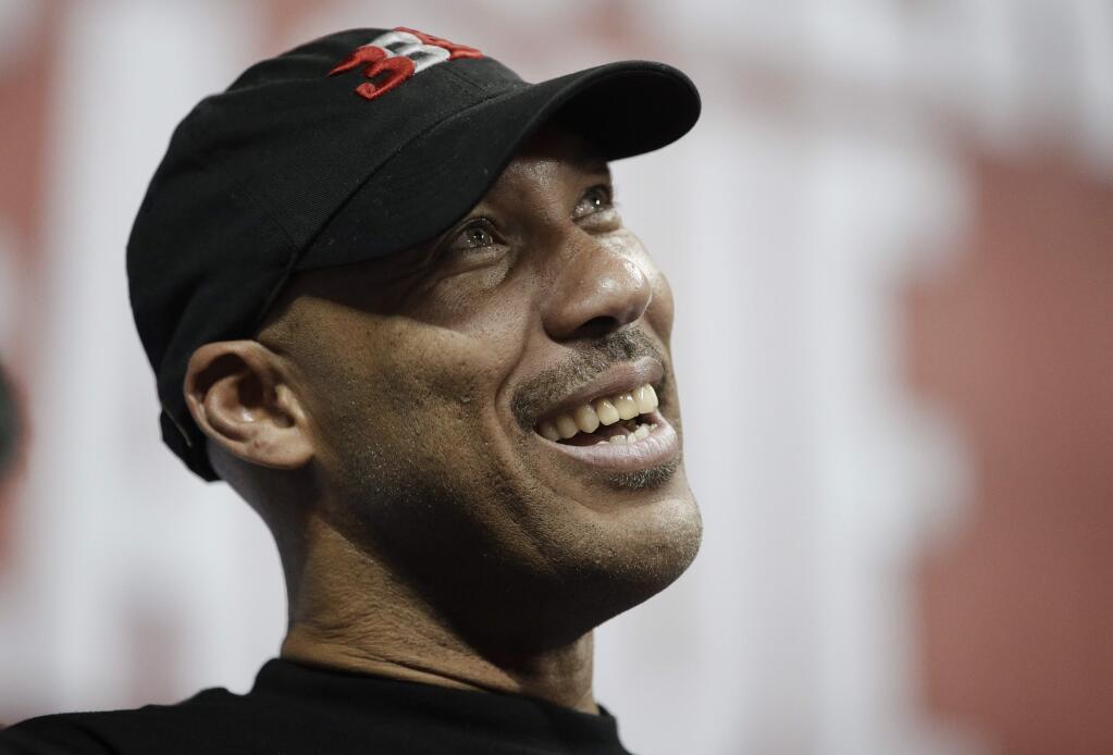 FILE - In this July 7, 2017, file photo, LaVar Ball, father of Los Angeles Lakers' Lonzo Ball and UCLA player LiAngelo Ball, watches the Lakers play the Los Angeles Clippers during an NBA summer league basketball game, in Las Vegas. President Donald Trump tweeted Sunday, Nov. 19, that he should have left three UCLA basketball players, including LiAngelo Ball, accused of shoplifting in China in jail after LaVar Ball minimized Trump's involvement in winning the players' release during an interview Saturday, Nov. 18, with ESPN. (AP Photo/John Locher, File)