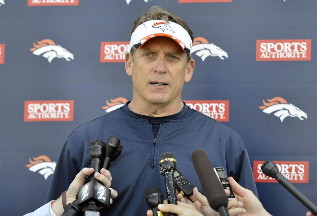 Broncos defensive coordinator Jack Del Rio talks to reporters at Denver's rookie camp in May. (Jack Dempsey / Associated Press)