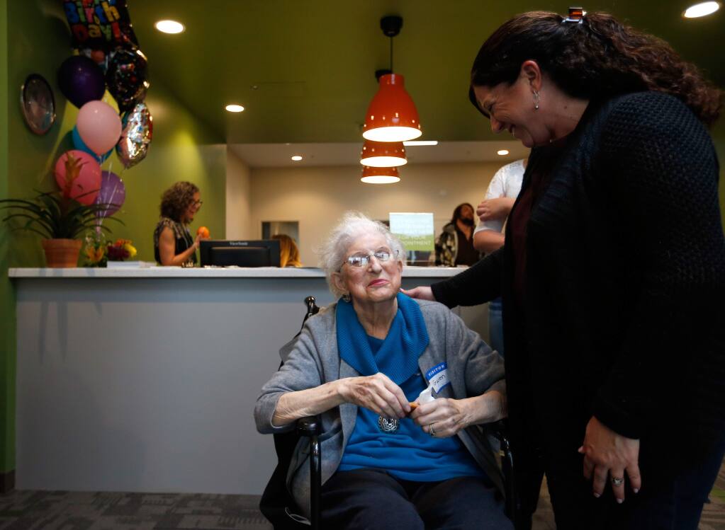 Spring Lake Village resident Gwen Zeller, left, who led the Dream Center fundraising efforts at the senior community, talks with her daughter, Jackie Avila, after a courtyard was dedicated to Spring Lake Village residents at the SAY Dream Center in Santa Rosa on Wednesday, Feb. 17, 2016. Residents of the Spring Lake Village senior community were the largest group of organized supporters and first financial donors to the SAY Dream Center. (Alvin Jornada / The Press Democrat)