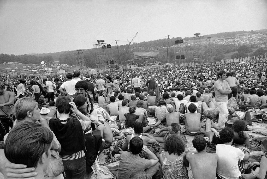 FILE - This Aug. 14, 1969 file photo shows a portion of the 400,000 concert goers who attended the Woodstock Music and Arts Festival held on a 600-acre pasture near Bethel, N.Y. For the first time, an audio recording is available of nearly everything heard onstage at Woodstock 50 years ago - from transcendent music to announcements about lost people and bad acid. It's the entire Woodstock experience, minus the mud. A 38-disc package 'Woodstock - Back to the Garden - The Definitive Anniversary Archive' is available now. (AP Photo/File)